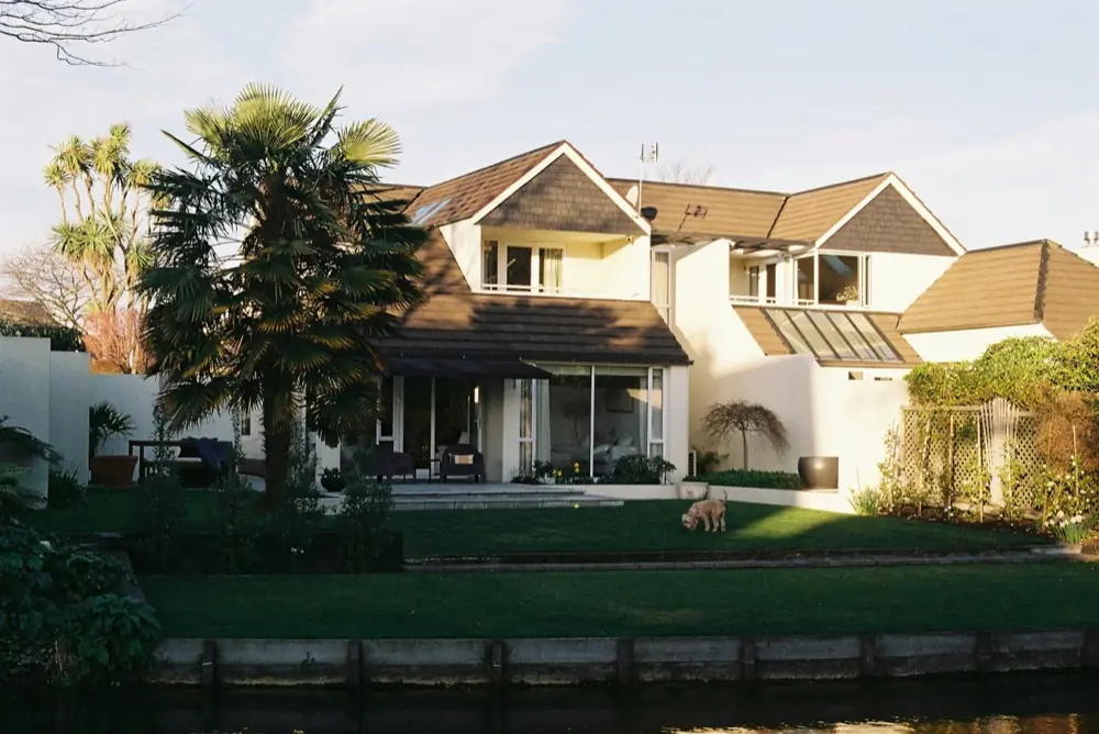 Upscale waterfront family home at golden hour, the kind of appreciated U.S. primary residence a Section 121 sale covers
